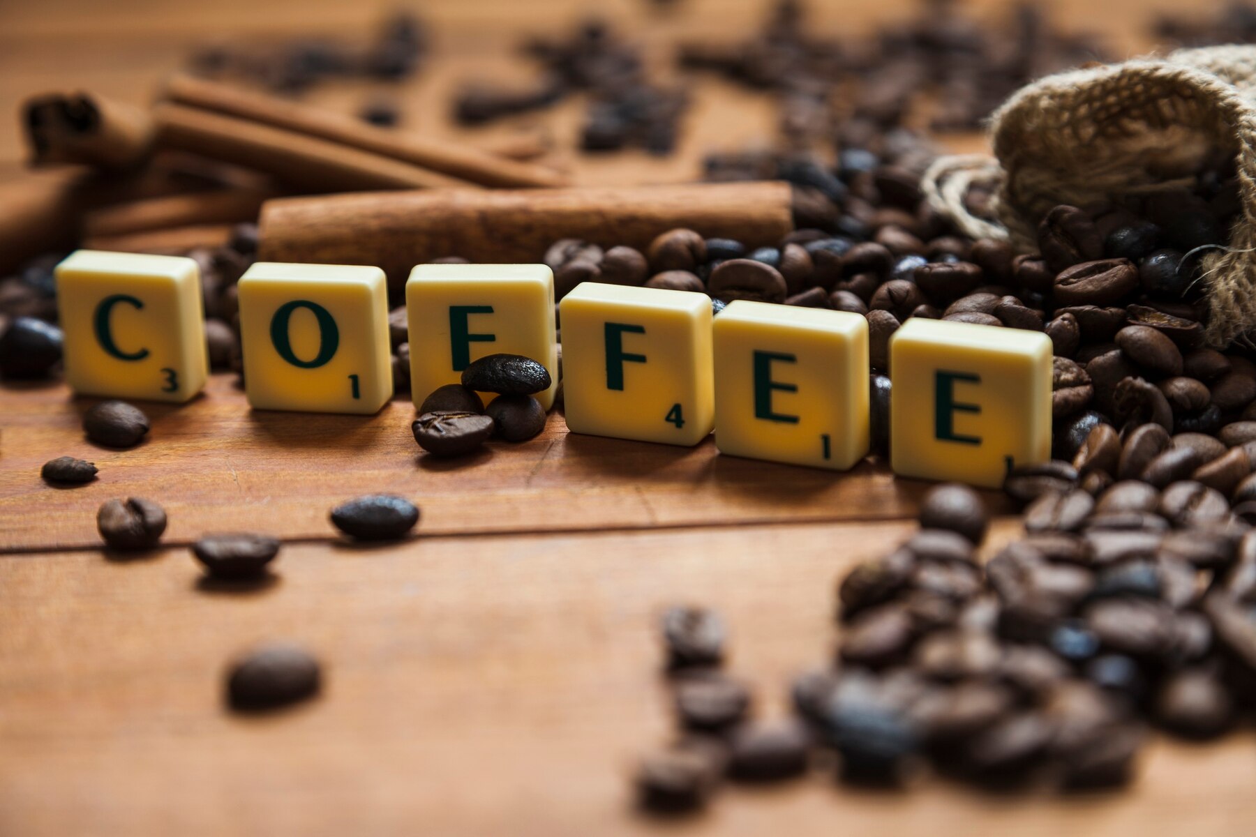 close-up-coffee-writing-near-beans_23-2147764914.jpg