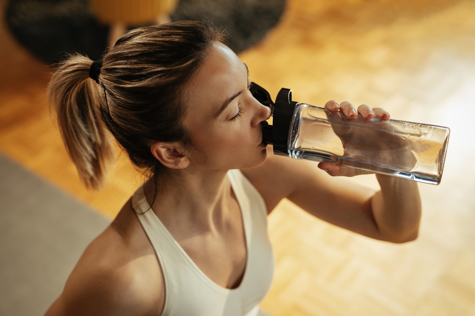 high-angle-view-athletic-woman-drinking-water-from-bottle-while-practicing-home.jpg high-angle-view-athletic-woman-drinking-water-from-bottle-while-practicing-home.jpg