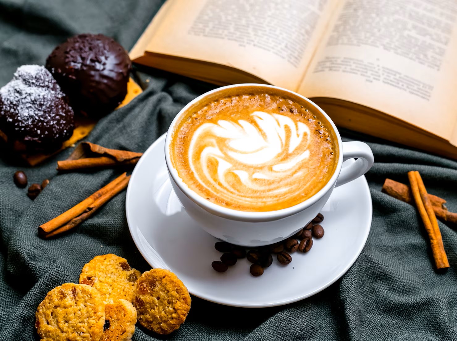 top-view-cup-of-cappuccino-with-chocolate-cookies-and-raisin-cookies-and-with-a-book-on-the-table_141793-2880.jpg