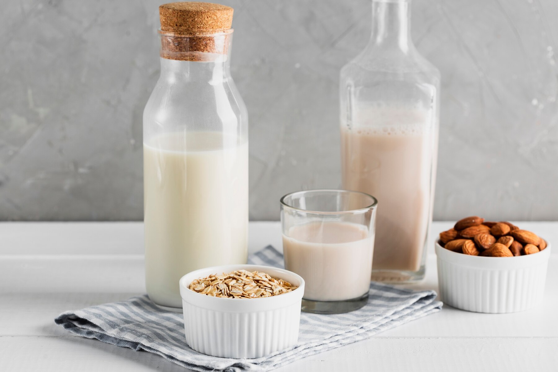 set-of-milk-bottles-and-glasses-with-oatmeal-and-almonds_23-2148356819 (1).jpg