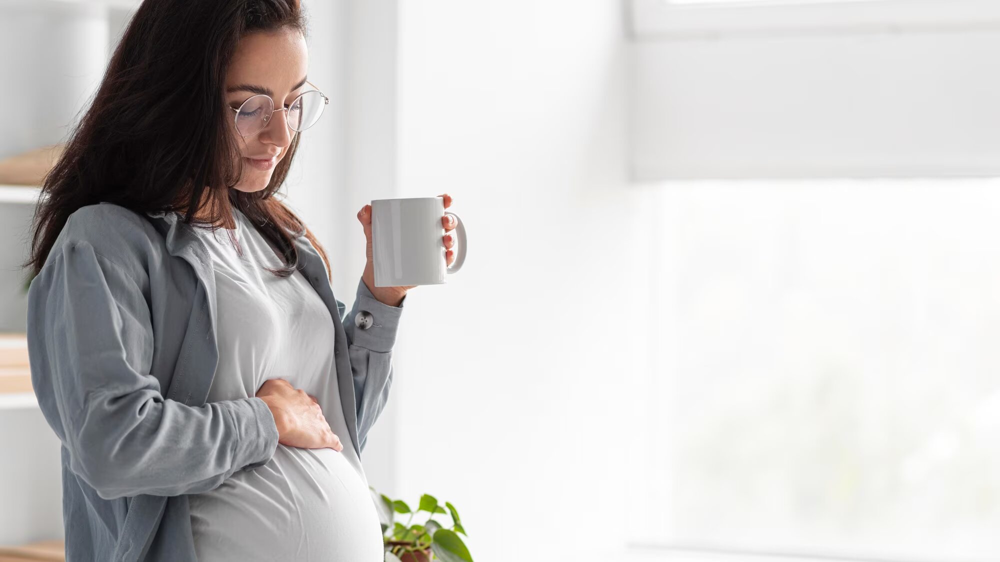 side-view-of-pregnant-woman-at-home-with-mug-of-coffee_23-2148765061.jpg.jpg
