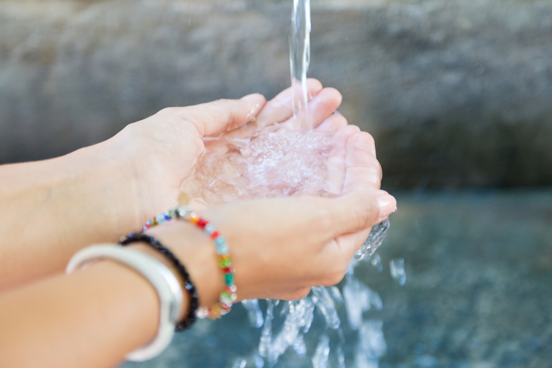 woman-s-hands-with-water-splash_1301-6711.jpg