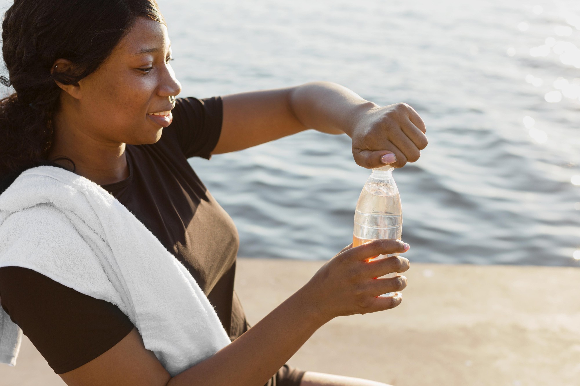 side-view-woman-opening-water-bottle-after-exercising.jpg