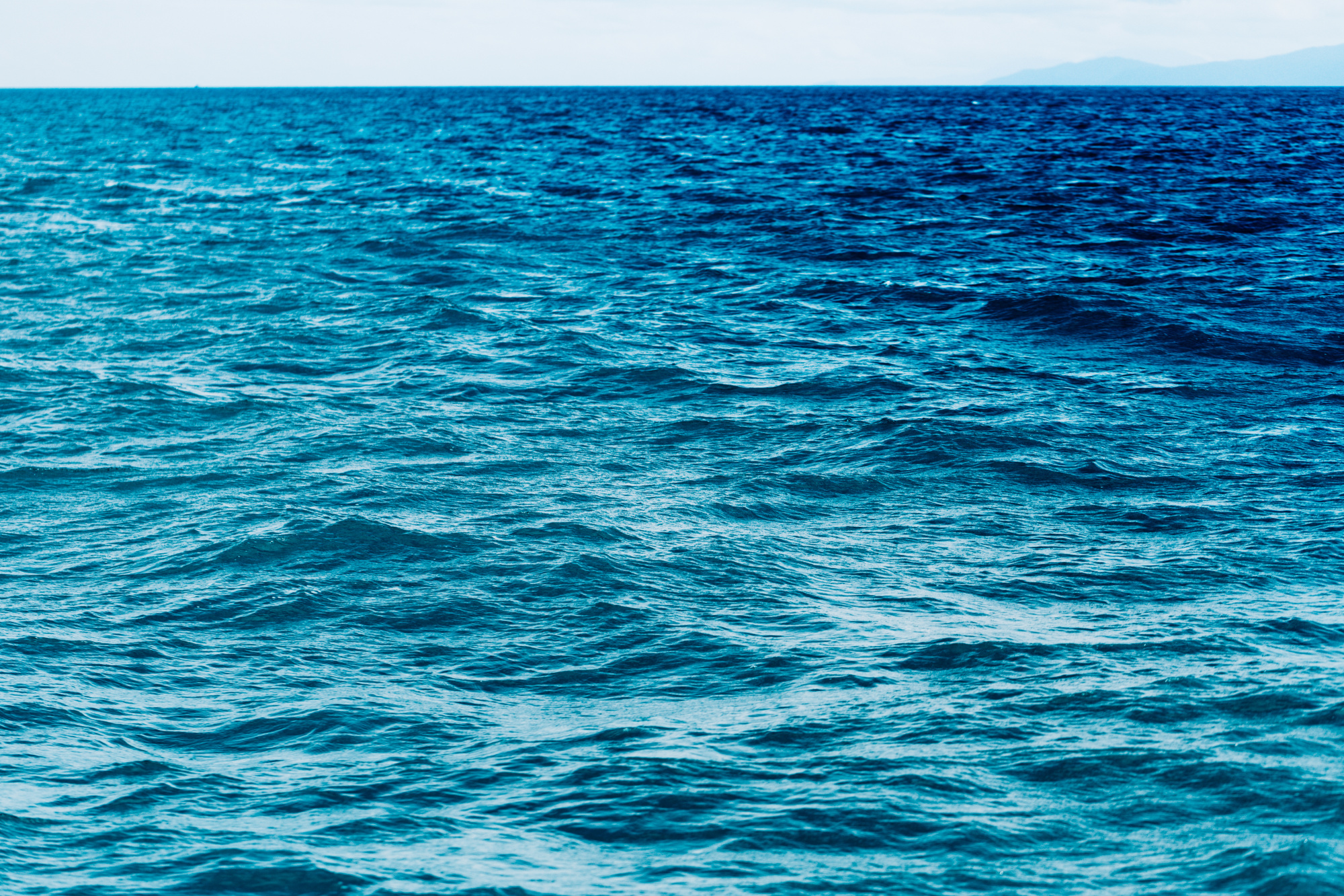 bright-blue-ocean-with-smooth-wave-background.jpg