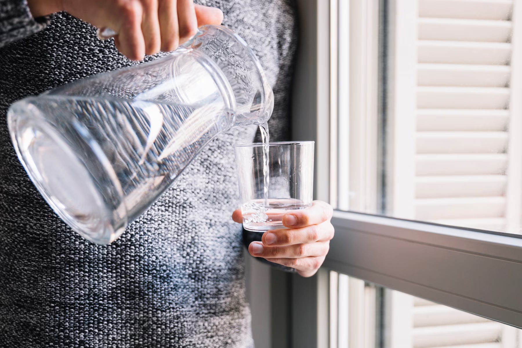 crop-man-pouring-water-near-window_23-2147765133.jpg.jpg