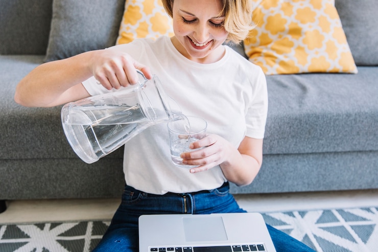 smiling-woman-with-laptop-pouring-water_23-2147765048 (1).jpg