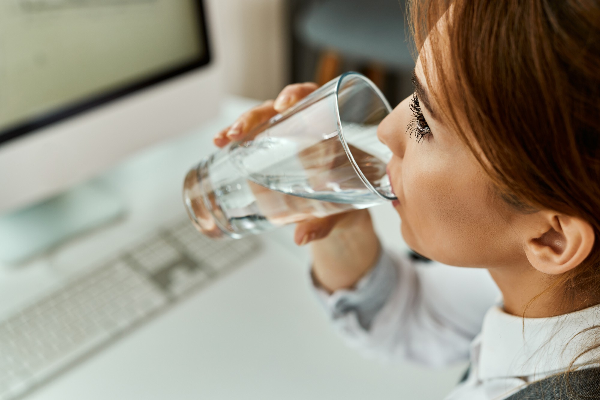 closeup-businesswoman-having-glass-water-while-working-un-office.jpg