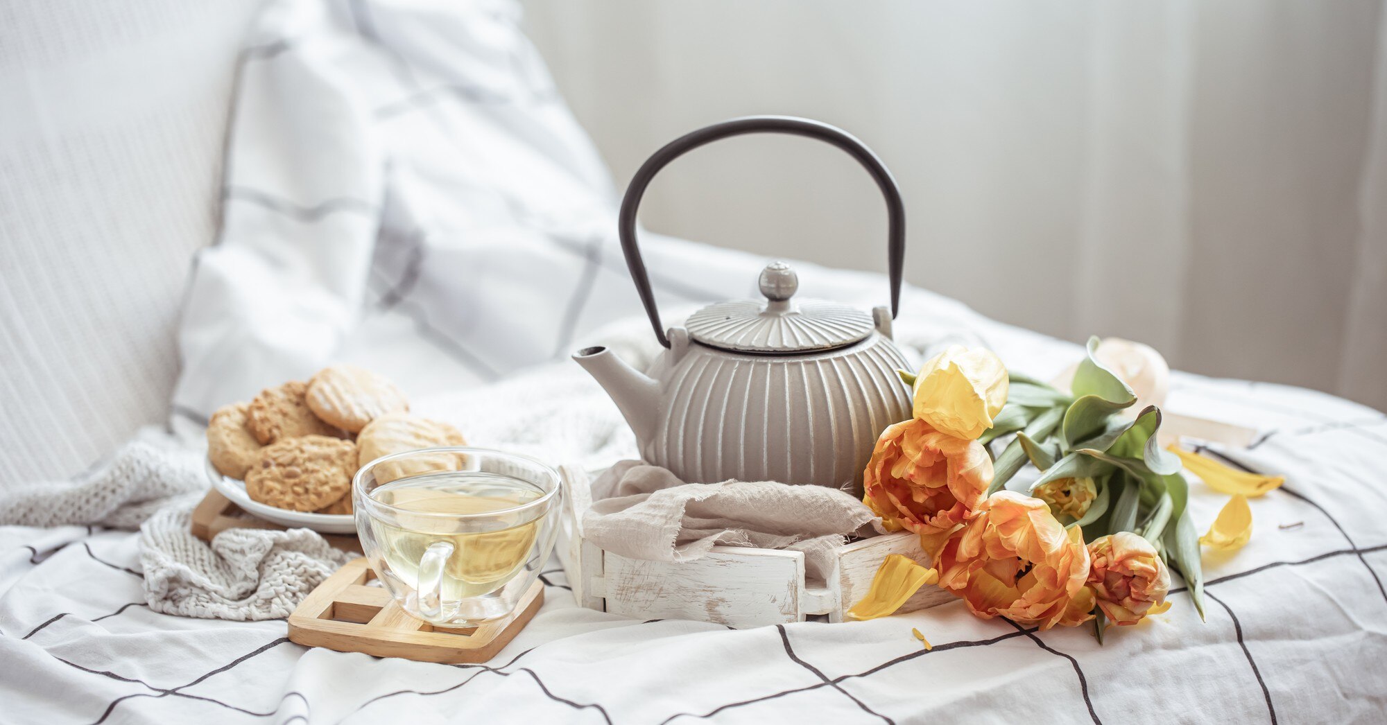 close-up-tea-cookies-bouquet-fresh-tulips-bed_169016-10370.jpg