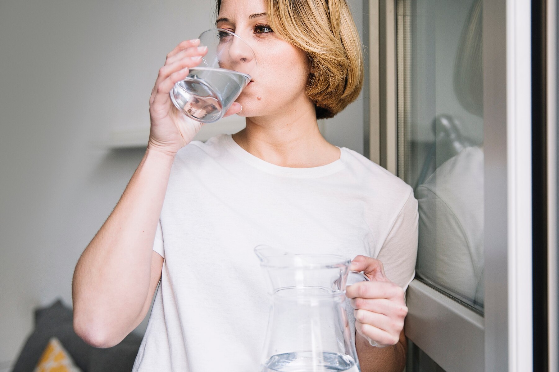 woman-drinking-water-near-window_23-2147765148 (1).jpg