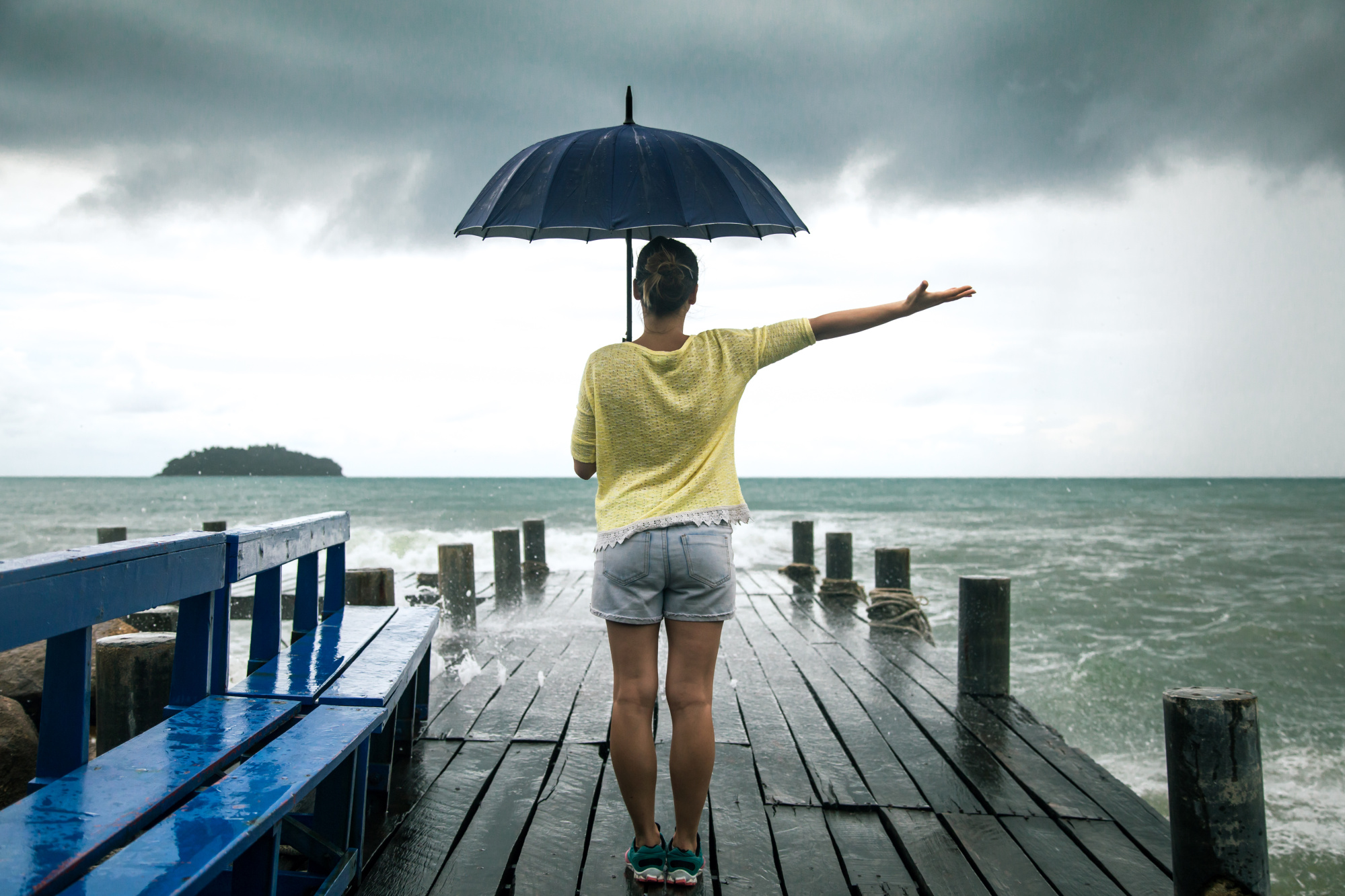 young-girl-pier-with-umbrella-stands-with-his-back-sea.jpg