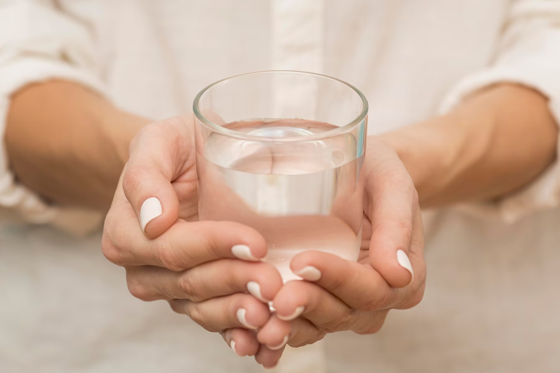 woman-holding-a-glass-filled-with-water_23-2148728797.jpg.jpg