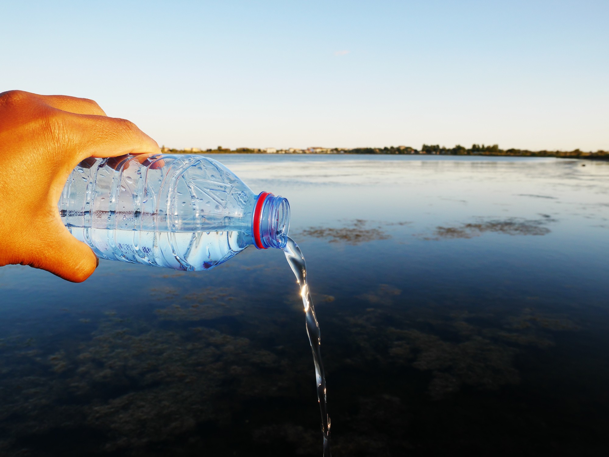 closeup-shot-plastic-water-bottle-human-hand-perfect-water-waste-concept.jpg