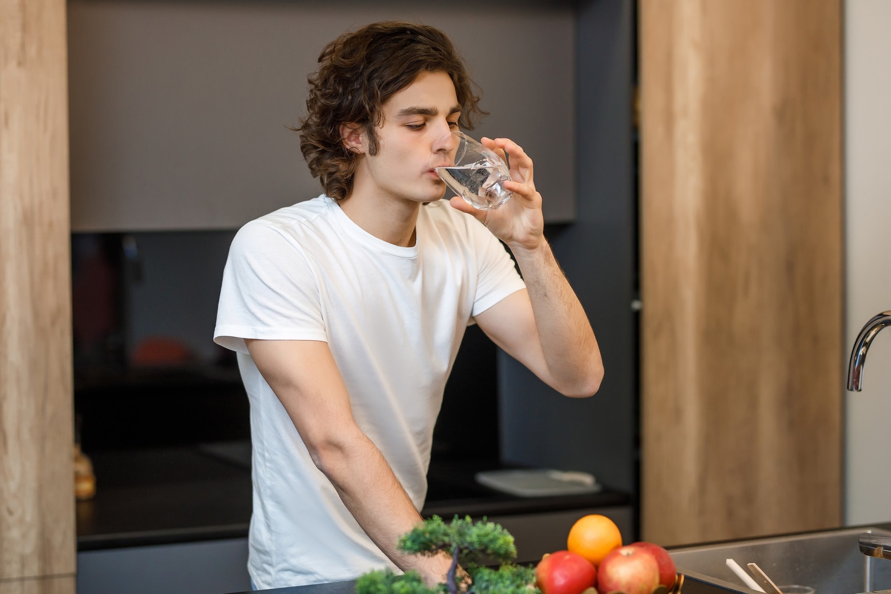 handsome-guy-stay-modern-kitchen-drinking-glass-water-morning-time_496169-1062.jpg