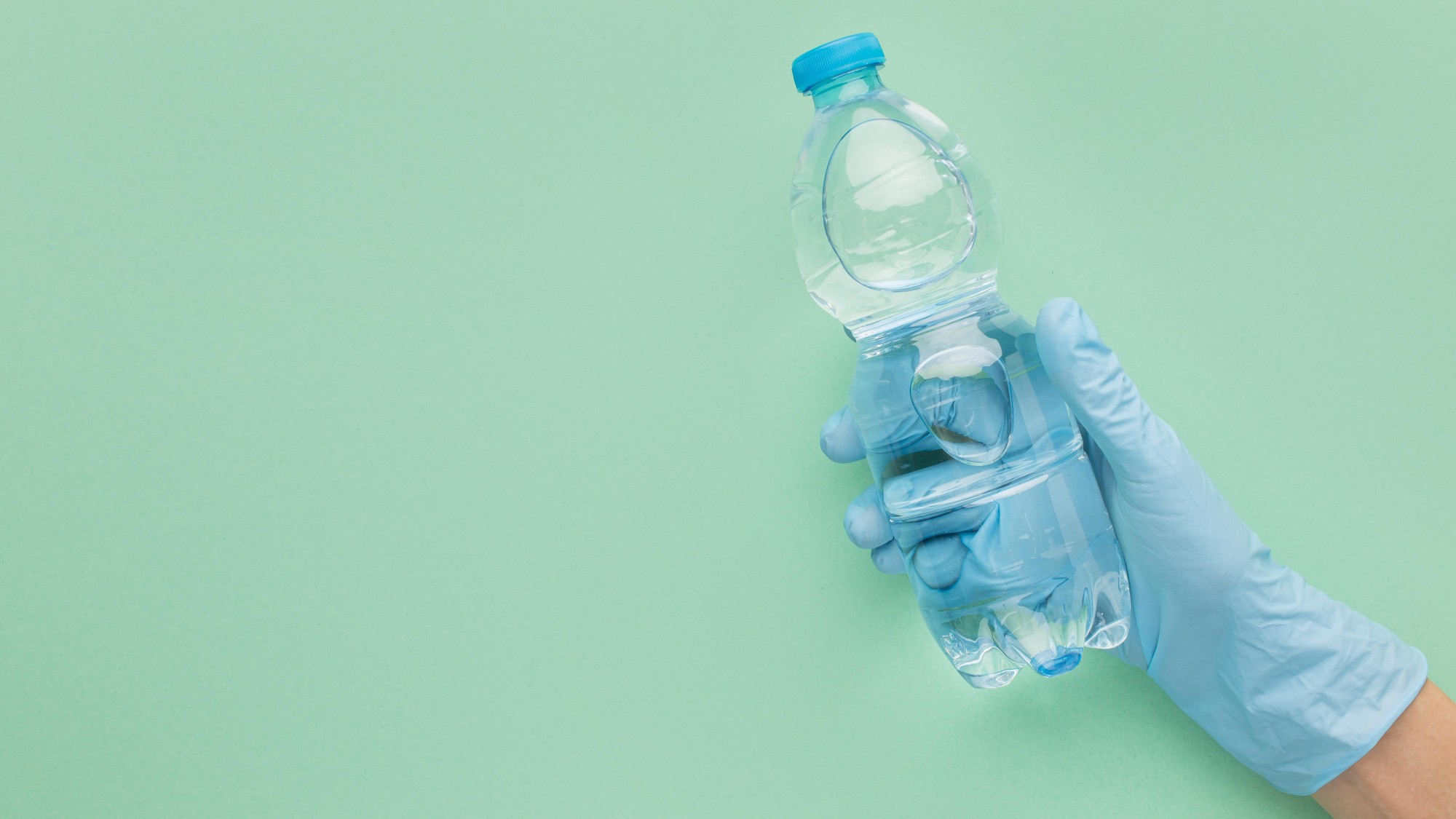 person-wearing-gloves-holding-plastic-bottle.jpg