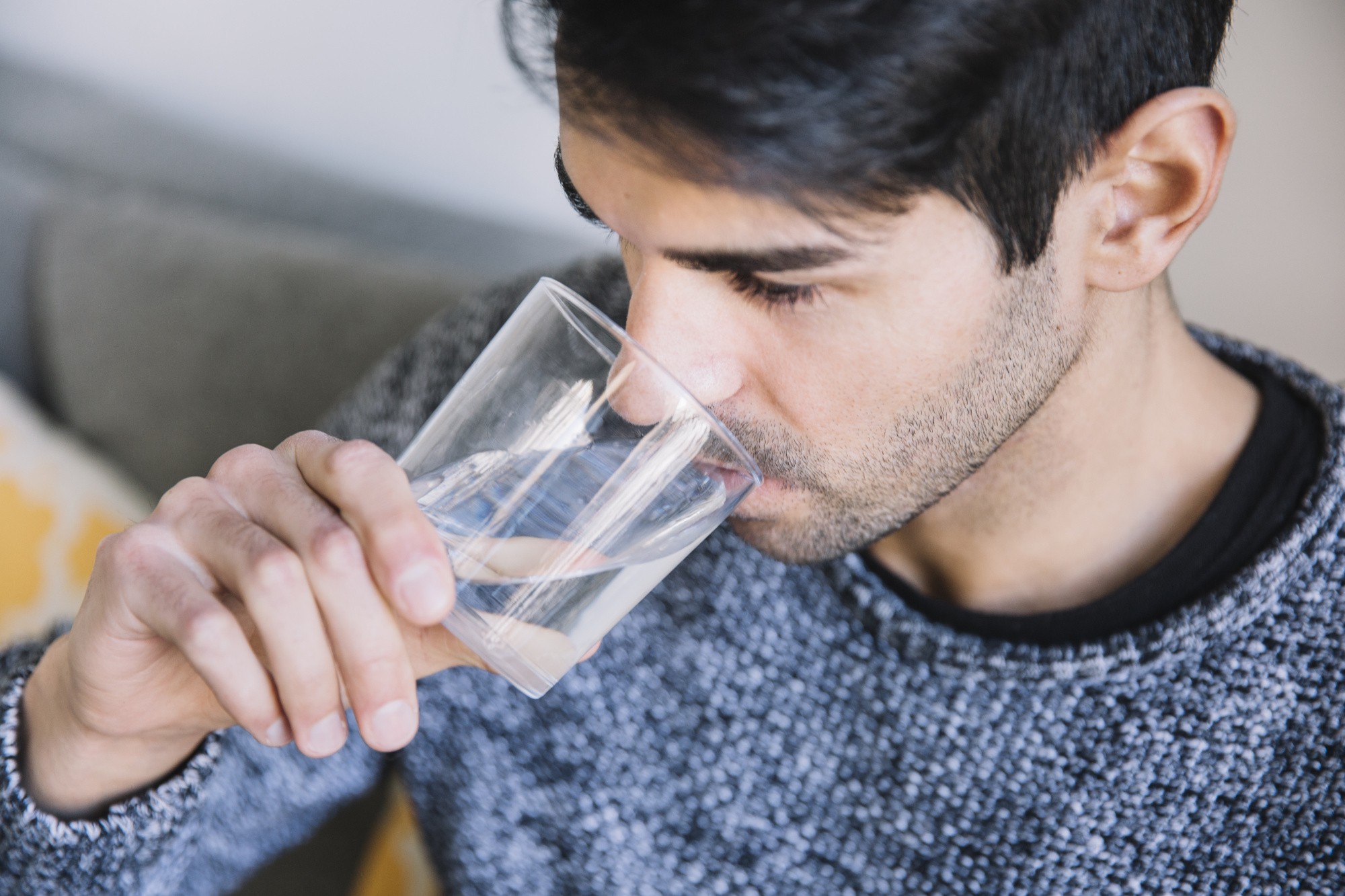 man-drinking-water-sofa.jpg